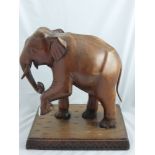 A Carved Figure of an Elephant, in wood, approx 41 x 30 x 45 cms.