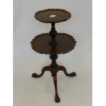 An Antique Mahogany Two Tier Occasional Table, having a scalloped edge with turned and carved ribbon