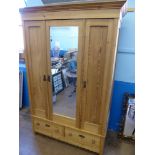 A Large Mirrored Pine Wardrobe with folding door and two drawers beneath, approx 52 x 210 x 58 cms.