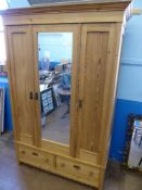 A Large Mirrored Pine Wardrobe with folding door and two drawers beneath, approx 52 x 210 x 58 cms.