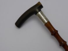 A Thorn Wood Shafted Walking Stick with wide silver band (Birmingham 1918) and horn handle.