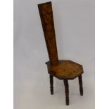 An Antique Oak Stick Back Chair, the chair having pen work design depicting flowers and fruit, on