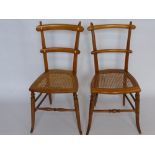 Two Oak Bedroom Chairs, rattan seats, splayed legs and turned stretchers. (2)