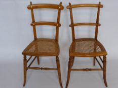 Two Oak Bedroom Chairs, rattan seats, splayed legs and turned stretchers. (2)