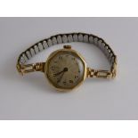 A 9 Ct Gold 375 Hallmark Lady's Vintage Rolex, having a silvered engine turned face, 15 rubies,