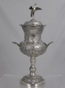 A 19th Century Chinese Sterling Silver Trophy Cup, twin handled and chased with figural scenes to