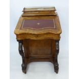 A Walnut Davenport with gilt tooled red leather insert, four interior drawers, four side drawers and