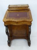 A Walnut Davenport with gilt tooled red leather insert, four interior drawers, four side drawers and