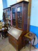 A Georgian Style Oak Drop Front Secretaire Book Case, the book case having glazed front with three