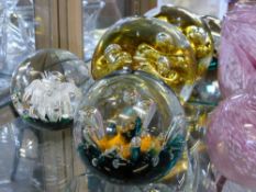 Three Glass Paperweights, including Caithness 'Sea Dance' and two others with bubble inclusions. (