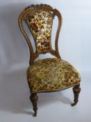 A Victorian Spoon Back Walnut Nursing Chair, the chair having carved leaves to top.