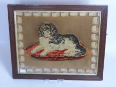 An Antique Tapestry depicting a King Charles Spaniel, approx 54 x 44 cms.