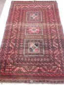 An Afghan Style Rug, on crimson ground with three central ghouls, approx 108 x194 cms