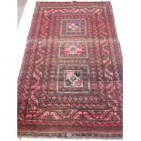 An Afghan Style Rug, on crimson ground with three central ghouls, approx 108 x194 cms