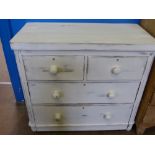 A 'Distressed' Pine Chest of Drawers, two short and two long, supported on bun feet.