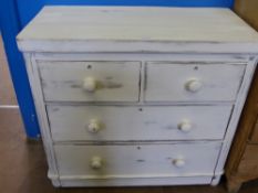 A 'Distressed' Pine Chest of Drawers, two short and two long, supported on bun feet.