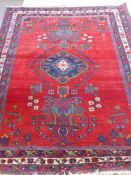 A "Kerrien Akshar Iranian Rug" Semi-Nomadic on crimson ground, approx 160 x 205 cms.