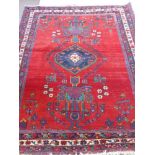 A "Kerrien Akshar Iranian Rug" Semi-Nomadic on crimson ground, approx 160 x 205 cms.