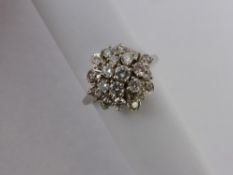 A Lady's 18 ct White Gold and Diamond Cluster Ring, size N, 64 pts total dias, approx 5.7 gms.
