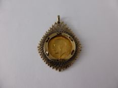 A 1914 George V Gold Half Sovereign, in 9 ct gold mount, approx wt of mount 4.9 gms,