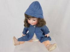 An Antique German Porcelain Headed Doll, the doll having open and closing eyes with impressed