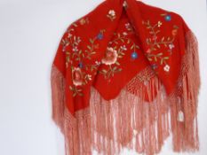 A Fringed Red Silk Mini Shawl with floral embroidered design.