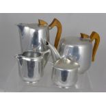 An Art Deco Style Brushed Steel Tea and Coffee Pot, together with a milk jug and sugar bowl.