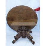 An Antique Oak Circular Dining Table, with elaborately carved column and pedestal base. The base