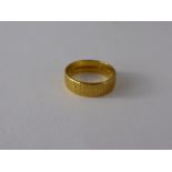 A 22 Ct Yellow Gold Bark Finish Wedding Band, size K, approx wt 4.2 gms.