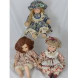 Three Leonardo Collection Porcelain Headed Dolls, in traditional costume with hand painted faces