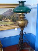 A Brass and Wrought Iron Oil Lamp, with green glass shade, approx 84 cms h.