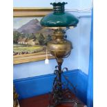 A Brass and Wrought Iron Oil Lamp, with green glass shade, approx 84 cms h.