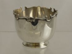 A Silver Sugar Bowl having a scroll top, London hallmark, mm F.B. & Co., dated 1924, approx 164