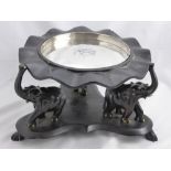 An Ebonised Indian Fruit Stand, the stand having three carved elephant supports with silver metal