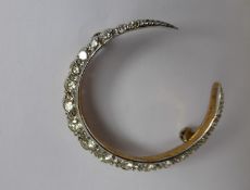 A Lady's 14 ct White and Yellow Gold and Diamond Moon Shape Brooch, the brooch set with approx 1.
