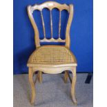 A Beech Wood Bedroom Chair with rattan seat.