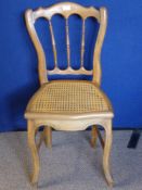 A Beech Wood Bedroom Chair with rattan seat.