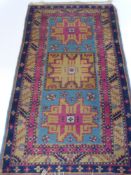 A Turkish Runner, on blue ground with  rose and mustard highlights with three central quadrangle