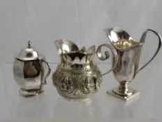 A Solid Silver Mustard Pot, helmet jug and an Indian silver cream jug.