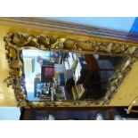 A Gilt Wood Mirror with decorative carving, approx 58 x 92 cms.
