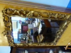 A Gilt Wood Mirror with decorative carving, approx 58 x 92 cms.