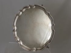 A Silver Salver, with pie crust edge supported on scroll feet, Sheffield hallmark, dated 1965, mm