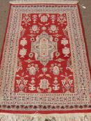 Two Middle Eastern Woollen Prayer Rugs, 1 blue approx 90 x 63 cms, the other red.approx 124 c 81