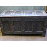 An Antique Stained Oak Coffer, with decorative carving to the front panel, hinged lid over stile