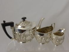 A Silver Bachelor Tea Trio, comprising teapot, sugar bowl and milk jug, each piece embossed with