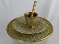 An Indian Brass Pestle and Mortar, together with a lattice work brass dish depicting Greek and