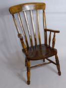 An Antique Oak Fireside Chair.