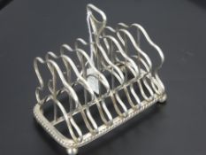 A Georgian Silver Toast Rack, the rack marked with lion passant and Georgian head with makers