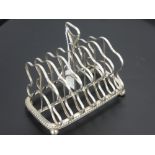 A Georgian Silver Toast Rack, the rack marked with lion passant and Georgian head with makers