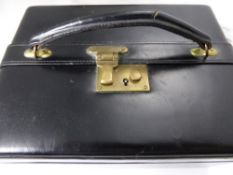 A Vintage Black Leather Jewellery Box, the box having black velvet lining with pull out ring tray